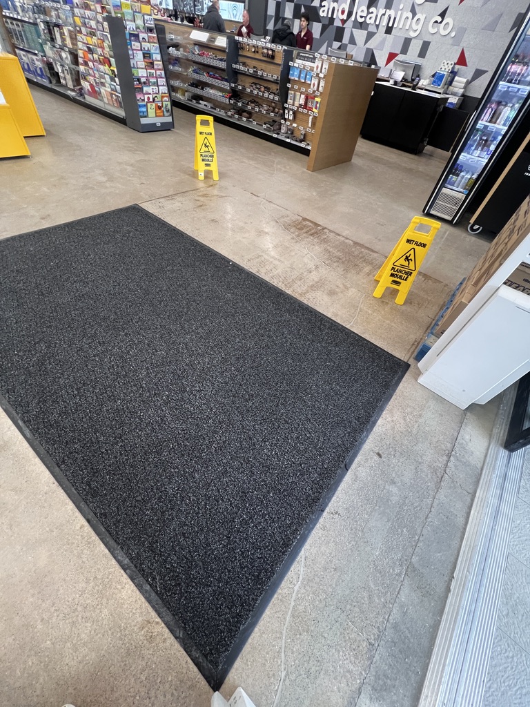 Clean commercial carpet at the store entrance after washing